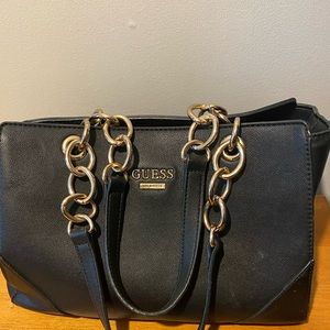 Guess handbag black in colour does not have shoulder strap.
